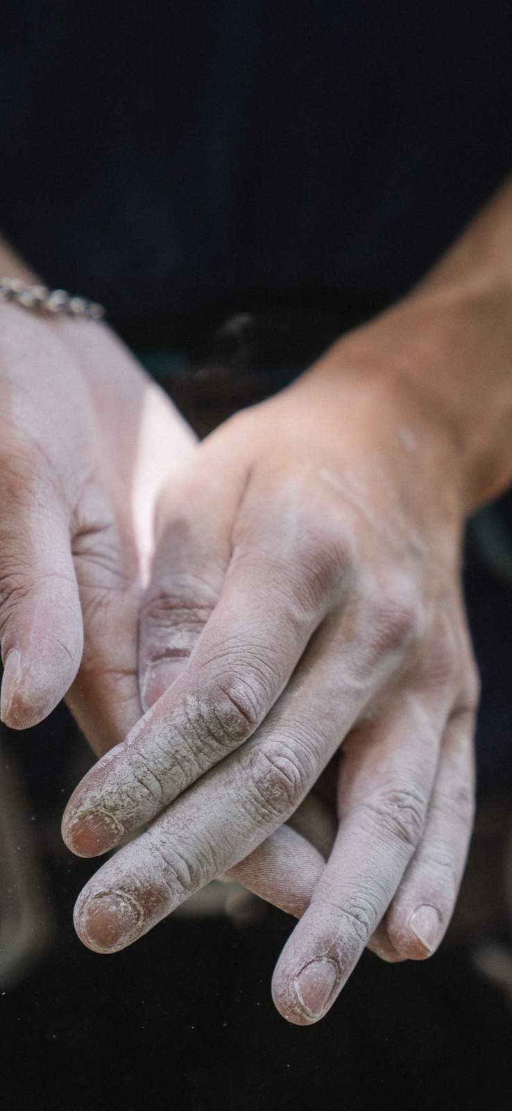 Two chalked hands pressed together